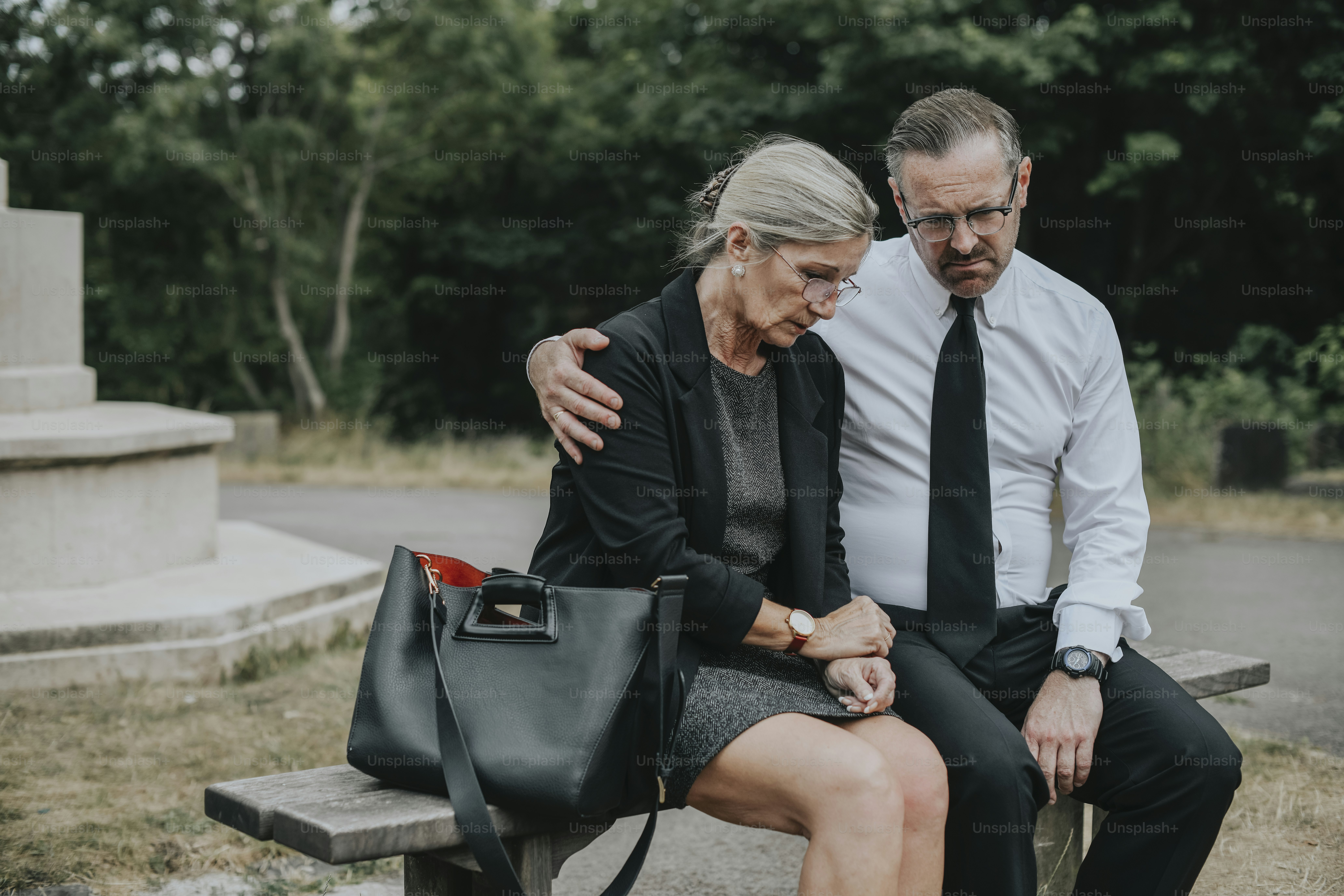 Couple grieving their loss at a cemetery